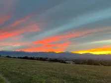 A gravel trail heading west toward the foothills at sunset
