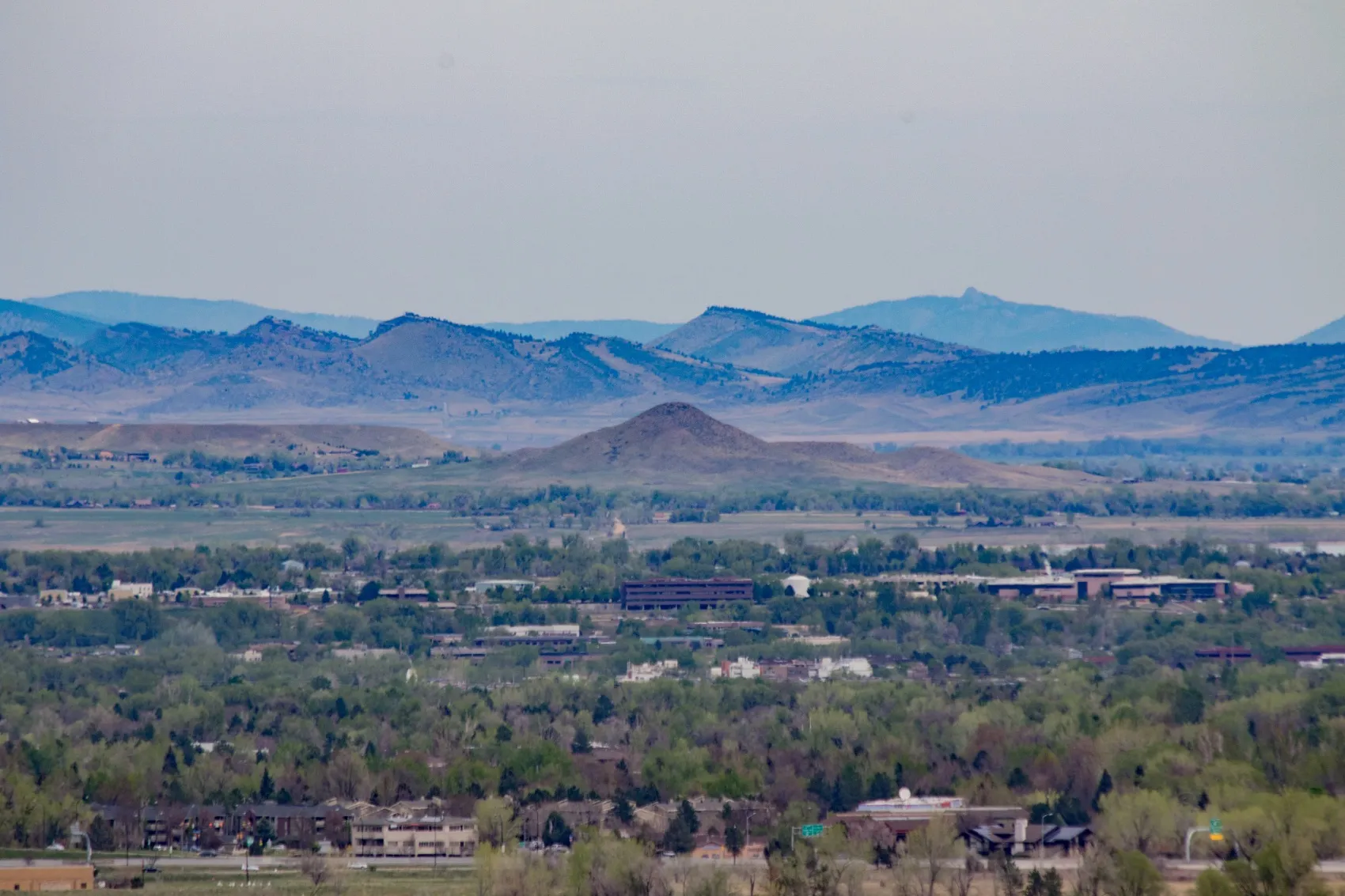 The valley floor below Niwot with a conical butte in the middle distance and the foothills of the Front Range behind it