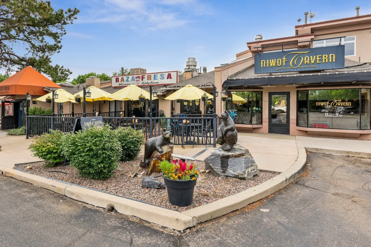 The covered patio outside Niwot Tavern, with the bear sculptures on the corner of Cottonwood Square