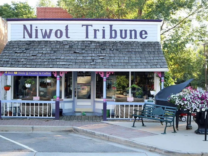 The Niwot Tribune false-front building on Second Avenue with a grand piano on the sidewalk