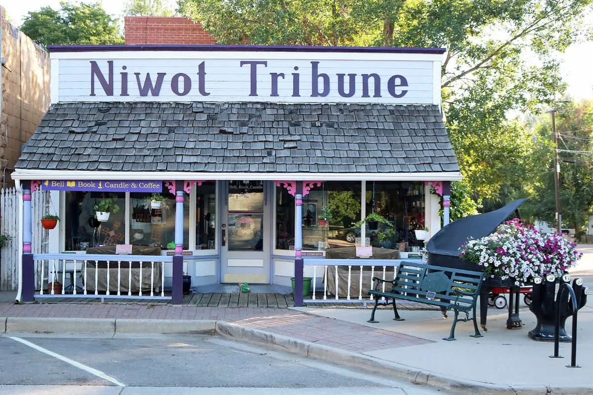 The Niwot Tribune false-front building on Second Avenue with a grand piano on the sidewalk