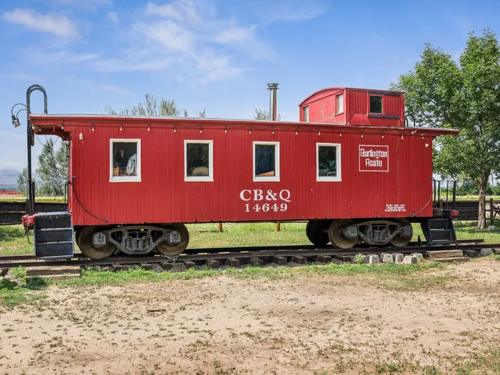 The red 1907 Burlington Route caboose on its short length of track at Whistle Stop Park