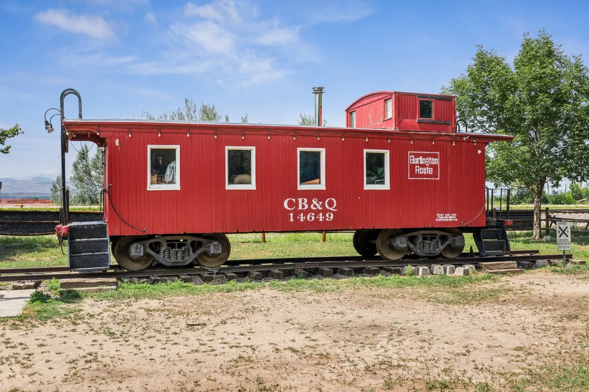 The red 1907 Burlington Route caboose on its short length of track at Whistle Stop Park