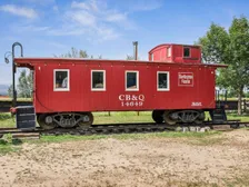 The red Burlington Route caboose at Whistle Stop Park, across from the Children’s Park
